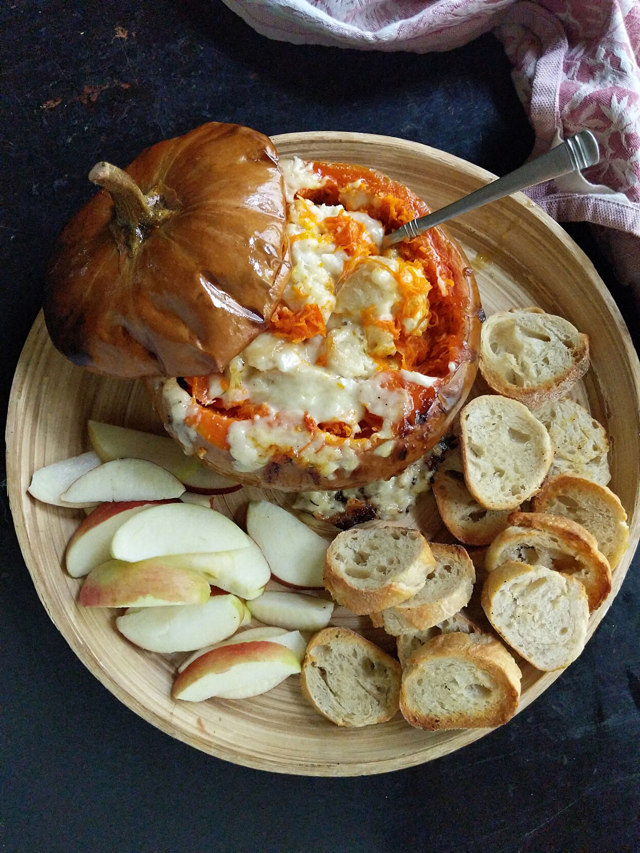 Roasted cheese pumpkin is stuffed with Gruyere and Swiss cheeses, cream and white wine for a creamy side dish or appetizer.